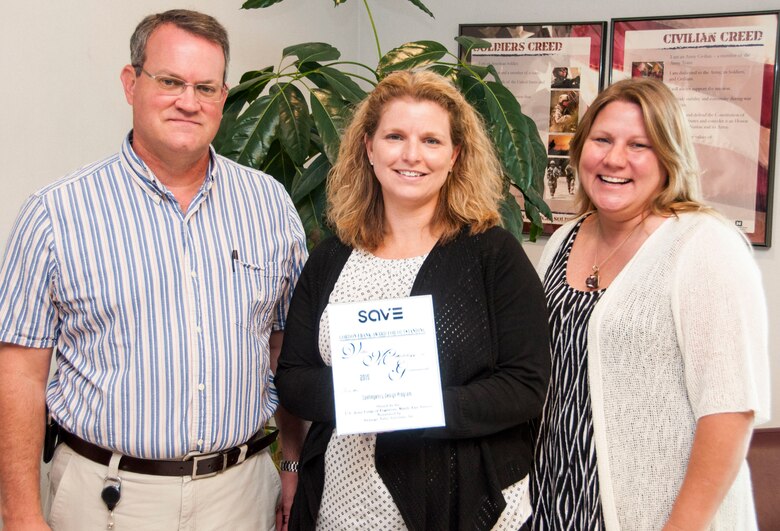 Dale Hartman, chief of the Middle East District’s Center of Standardization for Contingency Facilities, Amanda Bianchini, the district’s value engineering officer, and Tara Paxton, a program manager, pose with the Gordon Frank Award for Outstanding Value Methodology in Government that Bianchini accepted at the 2015 SAVE Value Summit in San Diego June 9.