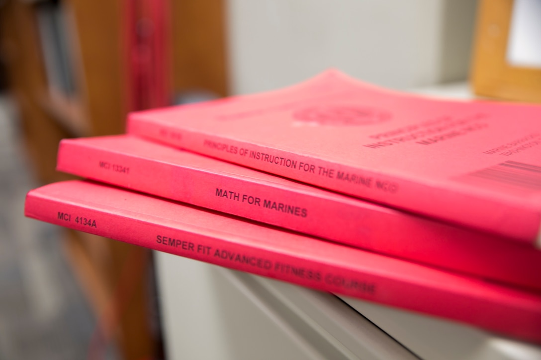 Examples of Marine Corps Institute course books stored at the Student Services Division, MCI, Marine Barracks Washington, D.C., June 5, 2015. The infamous red books of Marine Corps Institute that lined book shelves throughout the Marine Corps are no longer produced. After almost a century of service MCI is closing shop this September and ending another chapter of history at the “Oldest Post of the Corps”. The distance learning and education courses will be transferred to the familiar MarineNet platform. “With technology and times changing to computer based [platforms], it’s probably going to be easier for Marines to get their hands on [the courses],” said Master Sgt. Jason Bruce.