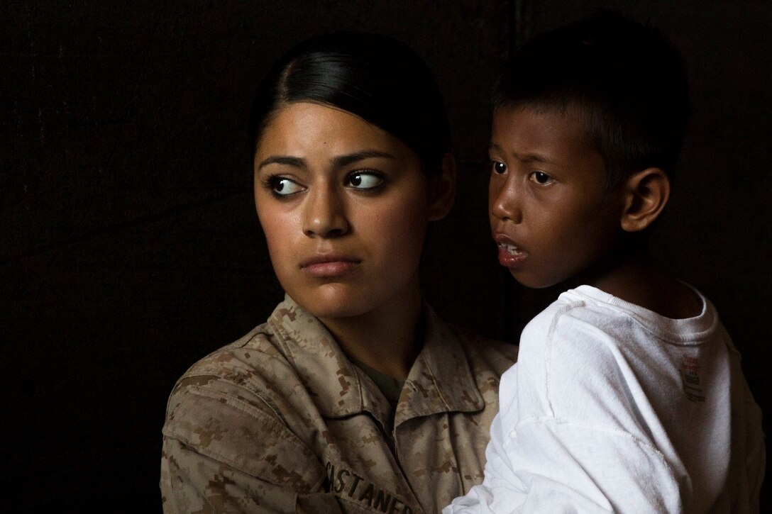 U.S. Marine Lance Cpl. Jasmine Castaneda comforts a distressed mariner aboard the USS Rushmore (LSD 47), after he was rescued from a sinking craft in the waters between the Indonesian islands of Kalimantan and Sulawesi, June 11, 2015. Castaneda is a supply warehouse clerk with Combat Logistics Battalion 15, 15th Marine Expeditionary Unit. Once on board, distressed mariners were provided food and medical attention by Marines and Sailors of the 15th MEU and Essex Amphibious Ready Group before being transferred to an Indonesian coast guard vessel. (U.S. Marine Corps photo by Sgt. Emmanuel Ramos/Released)