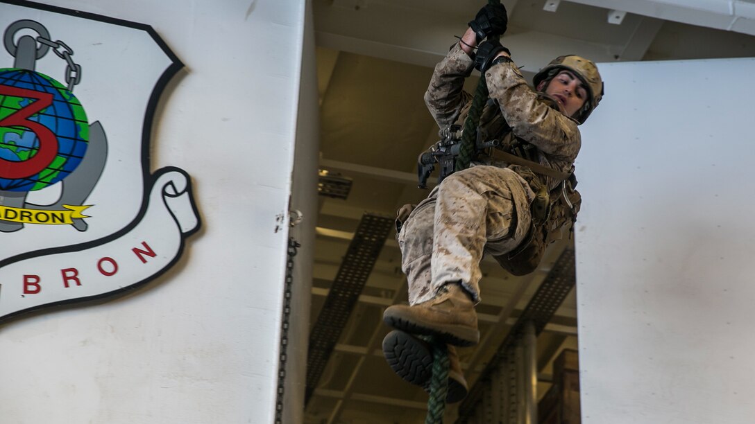 U.S. Marine Cpl. Nathan Kraus fast-ropes aboard the USS Essex (LHD 2) in the South China Sea, June 11, 2015. Kraus is a member of the 15th Marine Expeditionary Unit’s Maritime Raid Force. The MRF uses fast roping during visit, board, search, and seizure missions and precision ground raids when inserting from a helicopter. 