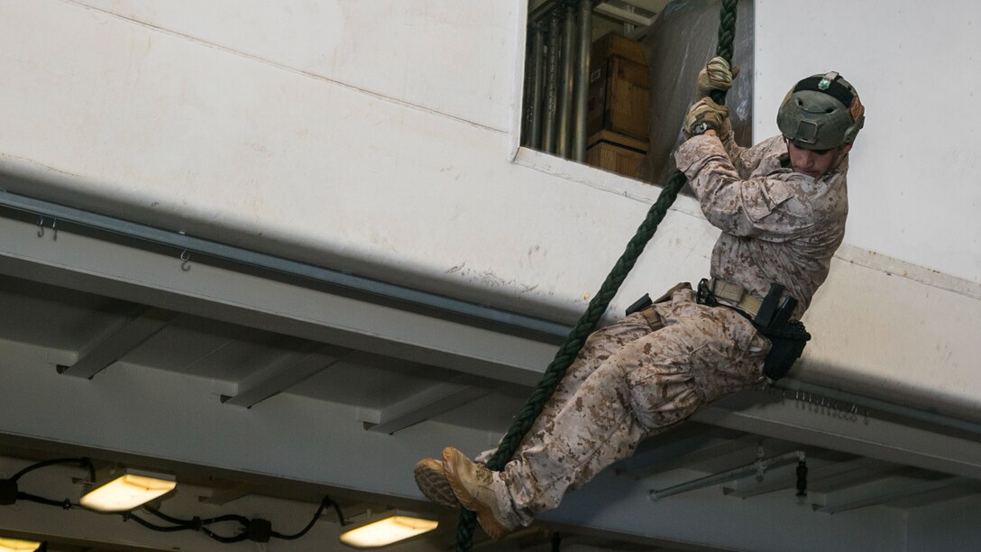 U.S. Marine Sgt. Joshua Mickles fast-ropes aboard the USS Essex (LHD 2) in the South China Sea, June 11, 2015. Mickles is with the 15th Marine Expeditionary Unit’s Maritime Raid Force. These Marines practice fast-roping so they are able to rapidly insert onto an objective via helicopter. 