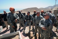 Army Gen. Frank Grass, chief, National Guard Bureau, and Air Force Chief Master Sgt. Mitchell Brush, his senior enlisted advisor, are briefed by a staff sergeant suring a visit to National Guard troops supporting the Multinational Force and Observers, Sinai, Egypt, June 1, 2015.