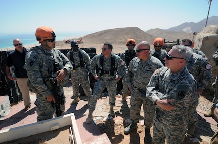 Army Gen. Frank Grass, chief, National Guard Bureau, and Air Force Chief Master Sgt. Mitchell Brush, his senior enlisted advisor, are briefed by a staff sergeant suring a visit to National Guard troops supporting the Multinational Force and Observers, Sinai, Egypt, June 1, 2015.