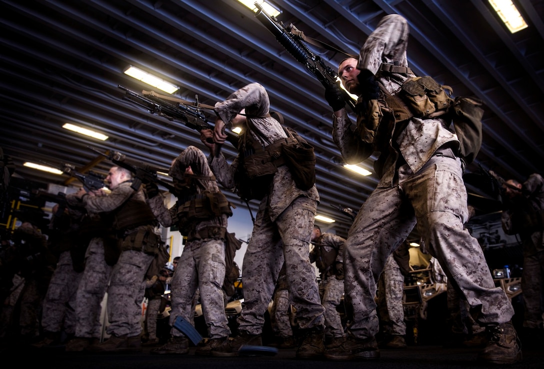 U.S. Marines with Light Armored Reconnaissance Detachment, Battalion Landing Team 3rd Battalion, 1st Marine Regiment, 15th Marine Expeditionary Unit, practice tactical and speed-reload drills with their rifles in the hangar bay of the USS Essex (LHD 2) in the East China Sea, June 3, 2015. The Marines with LAR Detachment continue to refine their skills during their seven-month deployment. (U.S. Marine Corps photo by Cpl. Elize McKelvey/Released)