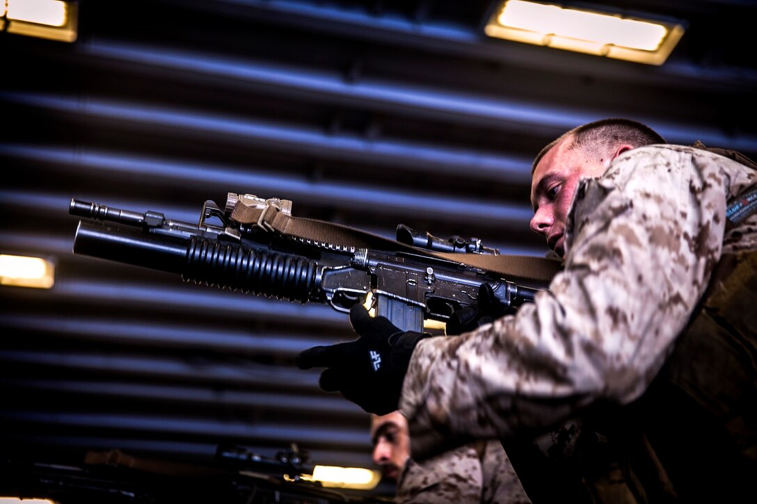 U.S. Marines with Light Armored Reconnaissance Detachment, Battalion Landing Team 3rd Battalion, 1st Marine Regiment, 15th Marine Expeditionary Unit, practice tactical and speed-reload drills with their rifles in the hangar bay of the USS Essex (LHD 2) in the East China Sea, June 3, 2015. The Marines with LAR Detachment continue to refine their skills during their seven-month deployment. (U.S. Marine Corps photo by Cpl. Elize McKelvey/Released)