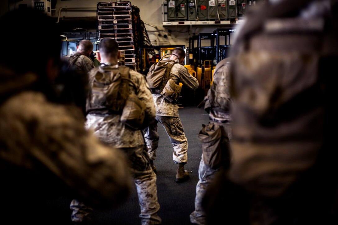 U.S. Marines with Light Armored Reconnaissance Detachment, Battalion Landing Team 3rd Battalion, 1st Marine Regiment, 15th Marine Expeditionary Unit, practice tactical and speed-reload drills with their rifles in the hangar bay of the USS Essex (LHD 2) in the East China Sea, June 3, 2015. The Marines with LAR Detachment continue to refine their skills during their seven-month deployment. (U.S. Marine Corps photo by Cpl. Elize McKelvey/Released)