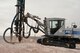 Staff Sgt. Steven Chalupnik, 820th RED HORSE special capabilities instructor, utilizes a rock drill to drill bore holes into a mountain during explosive demolition training at the 820th RED HORSE quarry on Nellis Air Force Base, Nev., June 9, 2015. The holes Chalupnik are drilling will be loaded with explosives and blasted, so the mountain rubble can be turned into construction material. (U.S. Air Force photo by Staff Sgt. Siuta B. Ika)