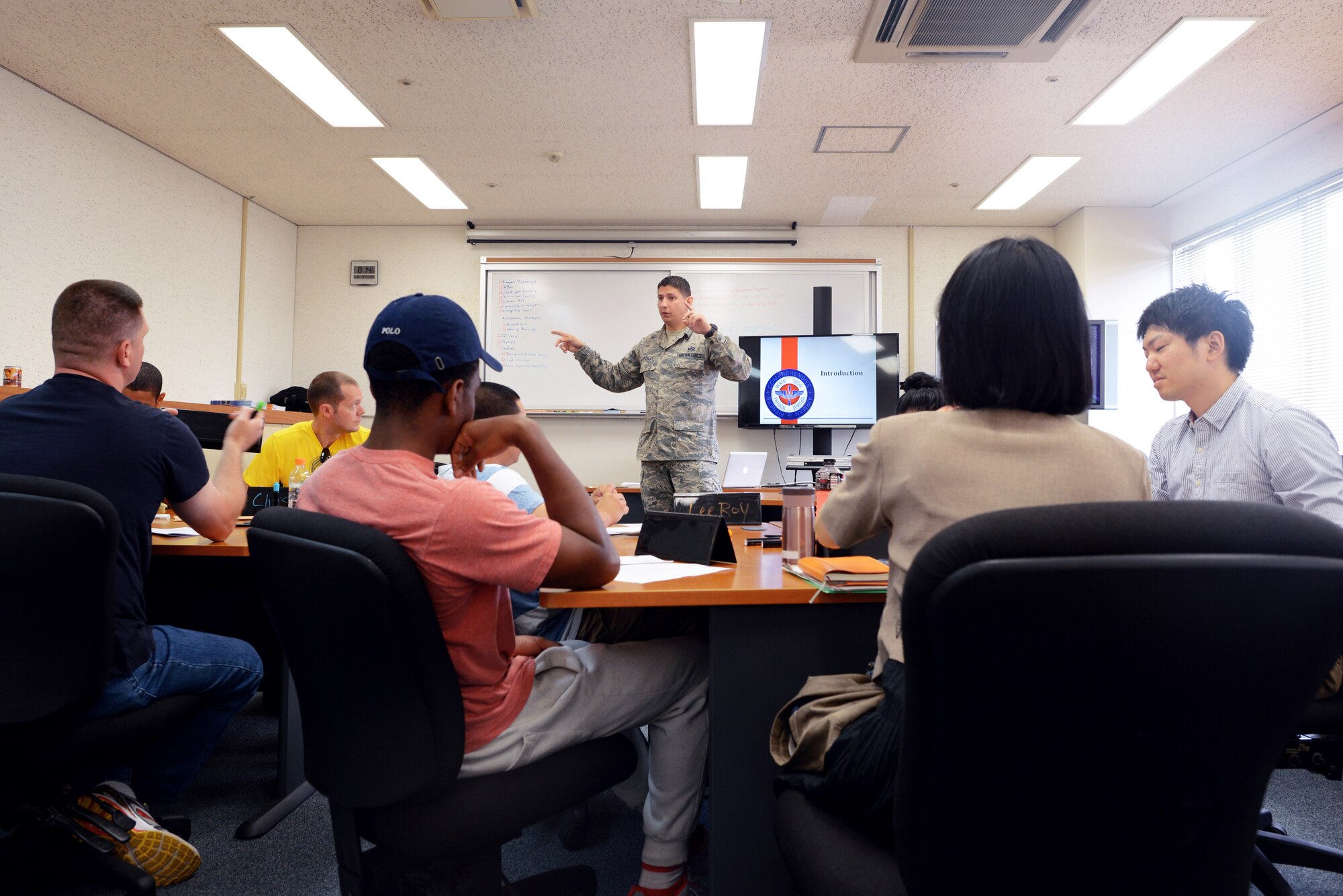 Tech. Sgt. Brock Atchley, 374th Operations Support Squadron master resiliency trainer, introduces  class topics at a bilateral resiliency training course June 4, 2015, at Yokota Air Base, Japan. The resiliency training, which included Japan Air Self-Defense Force Airmen, gave students the tools needed to handle stressful situations they might encounter in both their personal and professional lives. (U.S. Air Force photo by Airman 1st Class Delano Scott/Released)