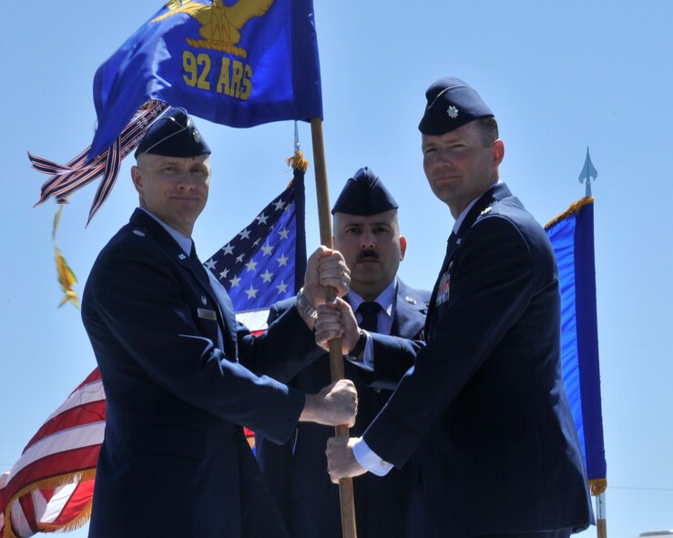 Lt. Col. David Pike, 92nd Operations Group deputy commander, presents the 92nd Air Refueling Squadron guidon to Lt. Col. Jason Brown, the new 92nd ARS commander, June 11, 2015, at Fairchild Air Force Base, Wash. Brown was the 92nd ARS director of operations before becoming the commander. (U.S. Air Force photo/ Airman 1st Class Taylor Bourgeous)