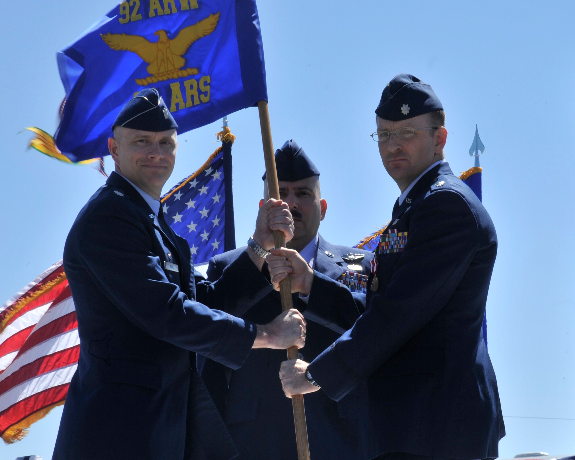Lt. Col. David Pike, 92nd Operations Group deputy commander, receives the 92nd Air Refueling Squadron guidon from Lt. Col. Jeromie Sheldon, the former 92nd Air Refueling Squadron commander, June 11, 2015, at Fairchild Air Force Base, Wash. Sheldon relinquished his position as the 92nd ARS commander in the change of command ceremony. The change of command is an official, formal and brief ceremony that is the military’s way of bestowing command responsibility of a unit to an officer. (U.S. Air Force photo/Airman 1st Class Taylor Bourgeous)