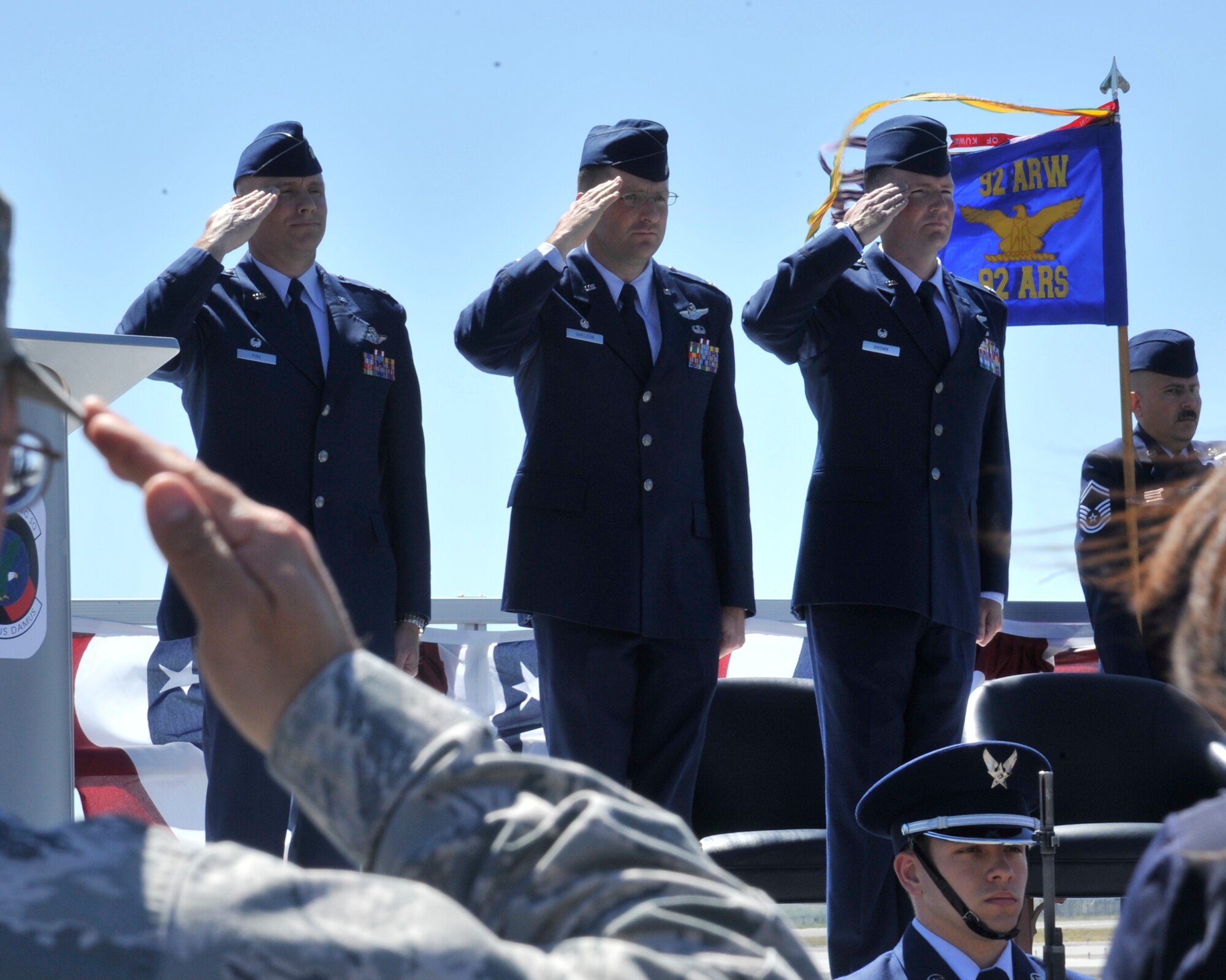 From left, Lt. Col. David Pike, 92nd Operations Group deputy commander, Lt. Col. Jeromie Sheldon, the former 92nd Air Refueling Squadron commander, and Lt. Col. Jason Brown, the new 92nd ARS commander, salute as the national anthem is played during the change of command ceremony June 11, 2015, at Fairchild Air Force Base, Wash. It is tradition to play the national anthem at the beginning of a change of command ceremony. (U.S. Air Force photo/Airman 1st Class Taylor Bourgeous)