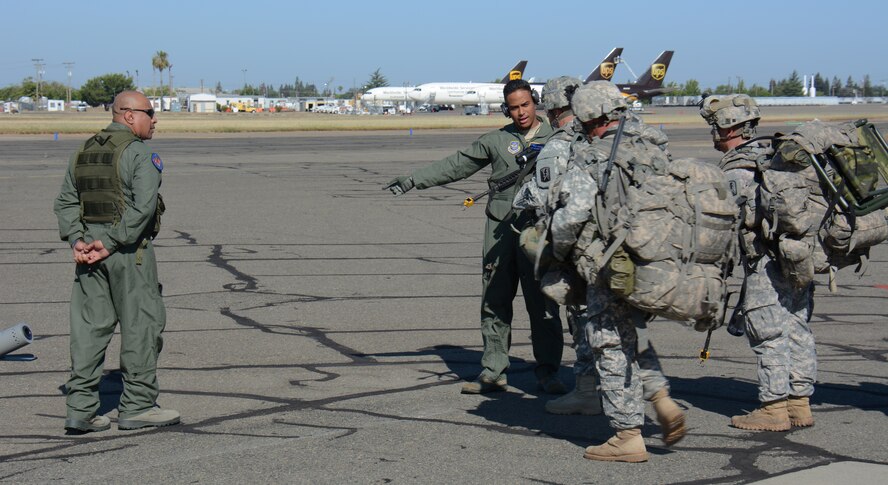 Staff Sgt. Alexander Bombita (Right), 349th Security Forces Squadron Phoenix Raven apprentice, instructs 24th Infantry Battalion Soldiers on clearing procedures June 6 at Mather Airport in Mather, Calif., as Staff Sgt. Juan Perez (Left), 349th SFS Phoenix Raven, looks on during the 349th Air Mobility Wing’s Air Force Specialty Code Training Weekend. The AFSC Training Weekend from June 6 - 7, 2015, centered around the wing's ability to respond to a major earthquake in northern California, while working in concert with other military, federal and state agencies to provide relief and support where needed. (U.S. Air Force photo/Tech. Sgt. James Hodgman)