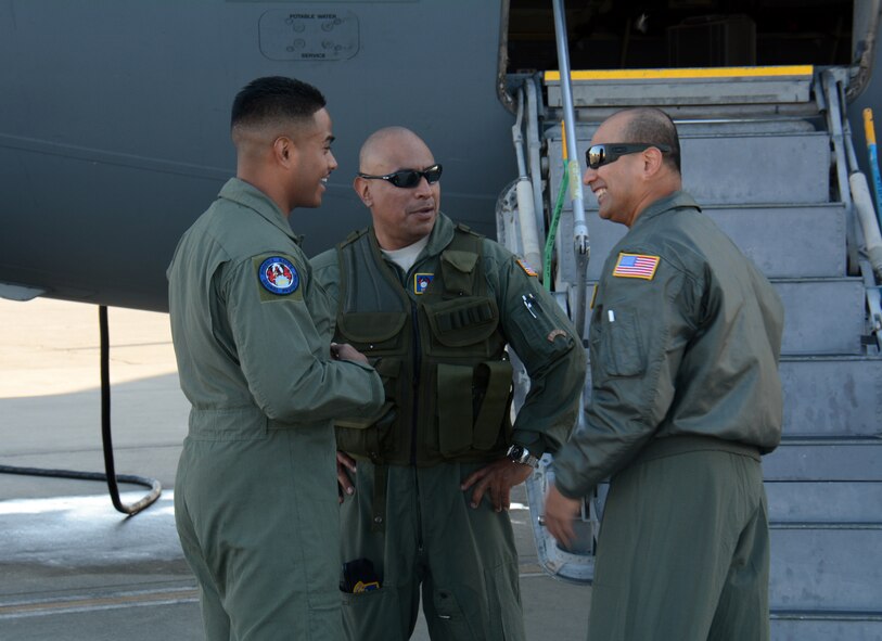 Staff Sgt. Juan Perez, a 349th Security Forces Squadron Phoenix Raven (center), speaks with Senior Master Sgt. Arnulfo Tumbaga (Right), 349th SFS superintendent of plans and programs, and Staff Sgt. Alexander Bombita (Left), a 349th SFS Phoenix Raven apprentice, June 6 outside a C-17 Globemaster III at Travis Air Force Base, California during the 349th Air Mobility Wing’s Air Force Specialty Code Training Weekend. Raven security teams are responsible for ensuring security of aircraft and personnel during missions. The AFSC Training Weekend from June 6-7, 2015, centered around the wing's ability to respond to a major earthquake in northern California, while working in concert with other military, federal and state agencies to provide relief and support where needed. (U.S. Air Force photo/Tech. Sgt. James Hodgman)