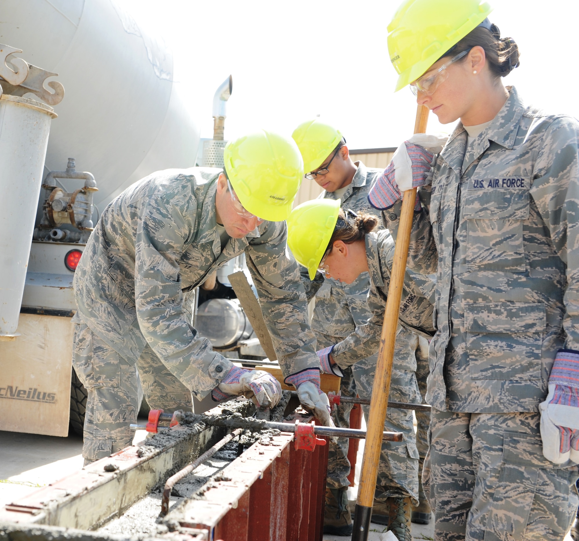 Cadet 2nd Class Christopher Amaddio, Cadet Squadron 33, smooths out the top layer of a concrete beam May 31, 2015. U.S. Air Force Academy cadets are taking part in the Academy's Field Engineering and Readiness Laboratory and building two homes for the Navajo Nation in New Mexico and Arizona. (U.S. Air Force photo/John Van Winkle)

