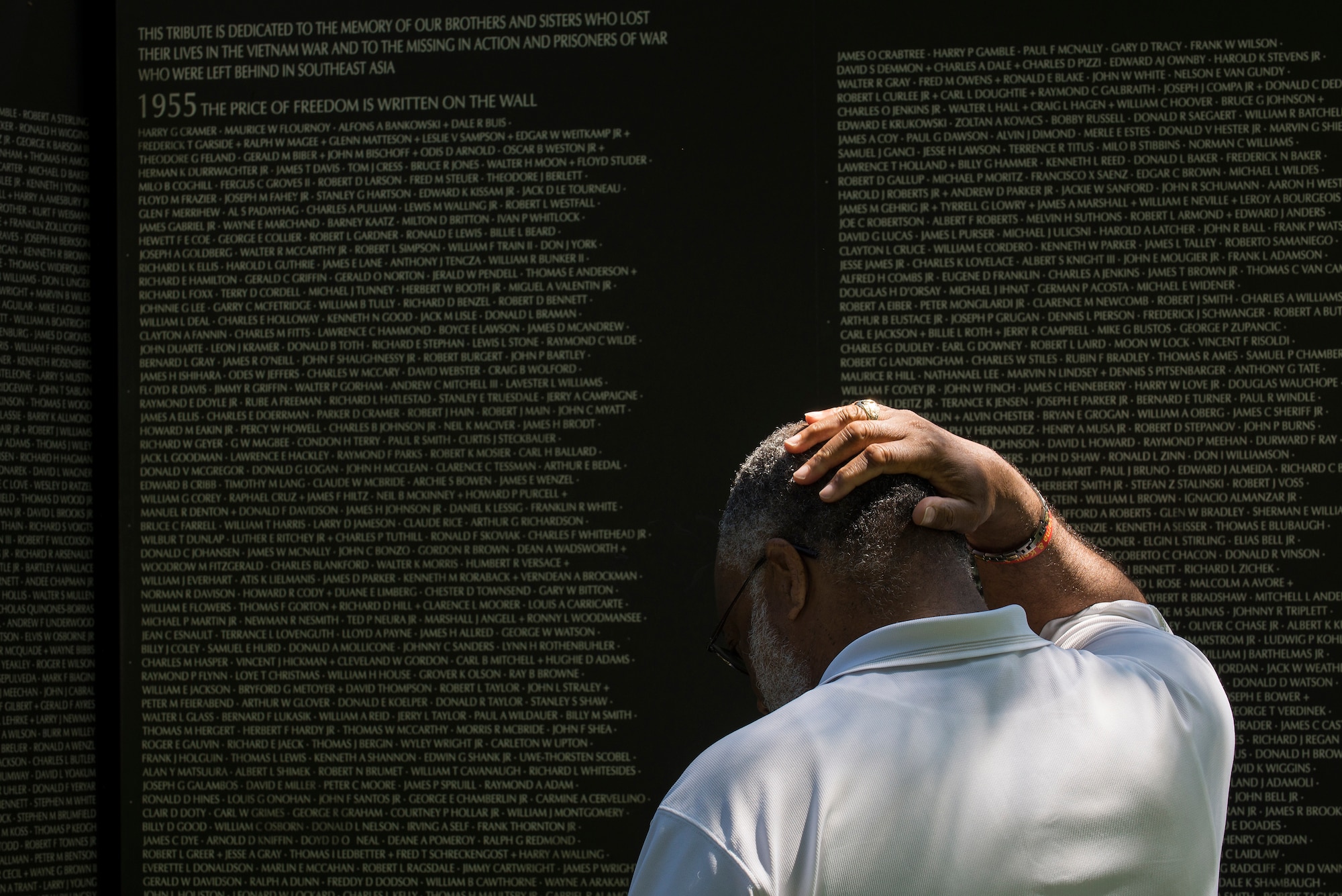 A man pauses to reflect after viewing the names that are listed in the traveling Vietnam Wall at the Eternal Flame Park, St. Louis, Missouri, June 5, 2015. A total of 58,272 names are listed on the Traveling Vietnam Wall. (U.S. Air Force Photo by Airman 1st Class Megan Friedl)