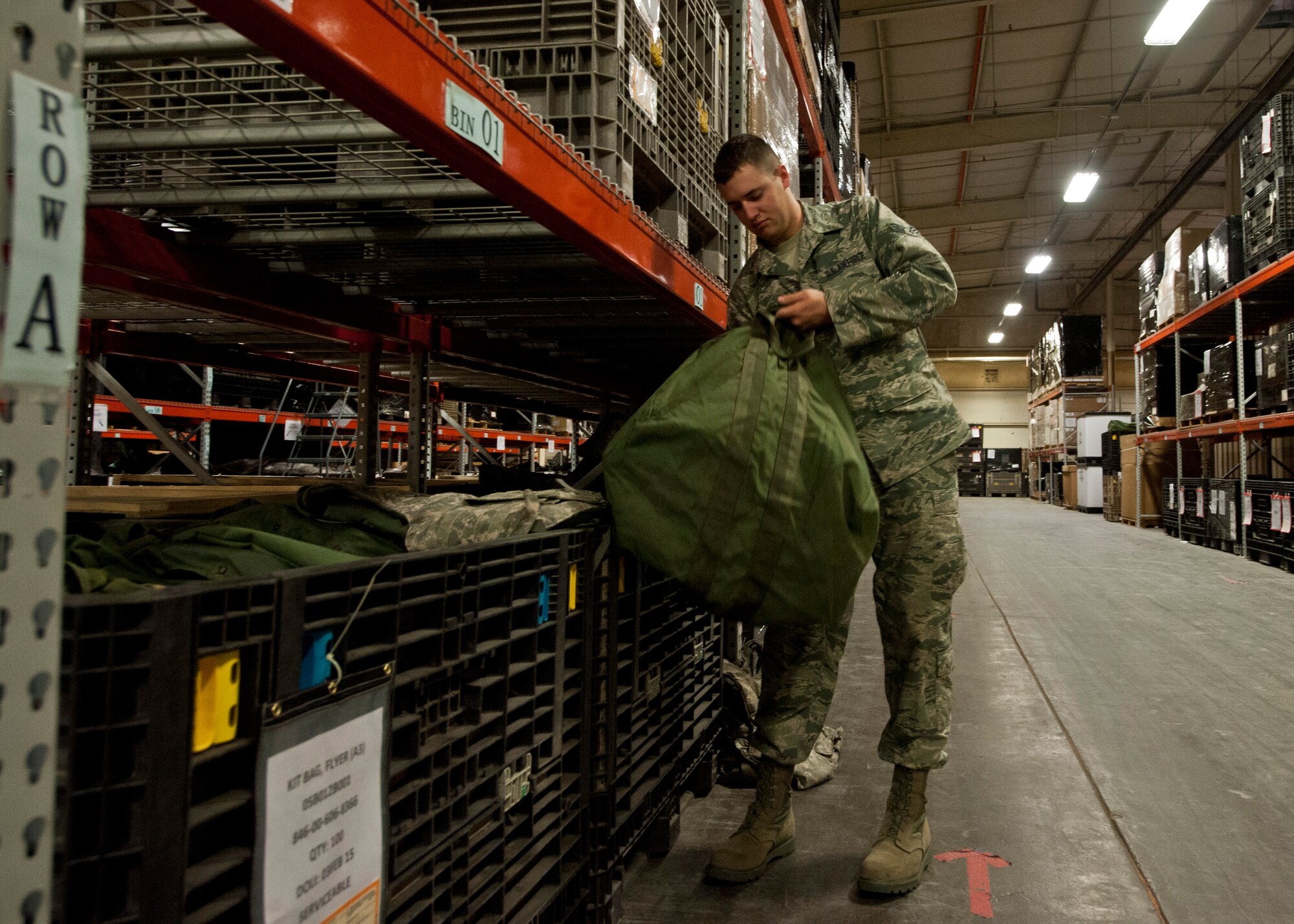 Senior Airman Nicholas Tendam, 99th Logistics Readiness Squadron individual protective equipment technician, fills a mobility bag with equipment at the installation deployment center on Nellis Air Force Base, Nev., June 10, 2015. The mission of the installation deployment  center is to is to notify units when taskings are received from Air Combat Command to support combatant commanders downrange. (U.S. Air Force photo by Airman 1st Class Jake Carter)