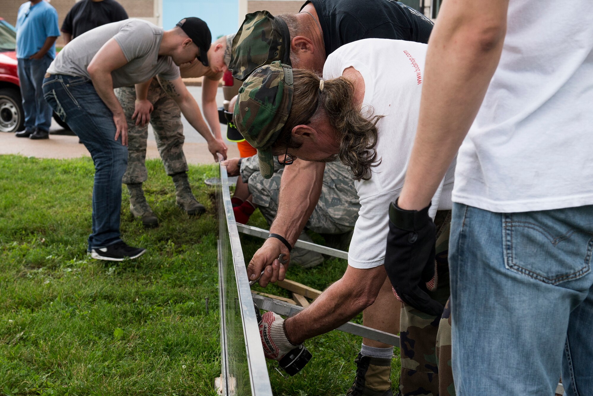 Volunteers from Scott Air Force Base and other organizations build the Traveling Vietnam Wall at the Eternal Flame Park, St. Louis, Missouri, June 4, 2015. The Traveling Vietnam Wall is a tribute dedicated to the memory of the servicemembers who lost their lives in the Vietnam War. (U.S. Air Force Photo by Airman 1st Class Megan Friedl)
