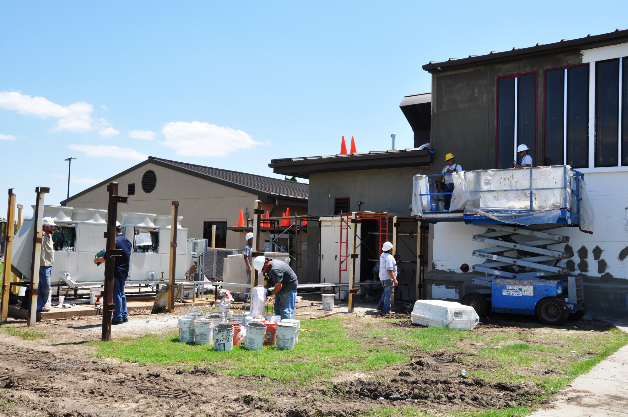 Despite climbing temperatures, workers continue the renovation of the base chapel June 11, 2015, at McConnell Air Force Base, Kan. Last January, the chapel moved from Building 510 to a variety of locations on the installation.  During the renovation, the chapel's heating, ventilation, and air condition system are being replaced.  The building is also getting new carpet, paint and a sound system.  (U.S. Air Force photo by Tech. Sgt. Abigail Klein)