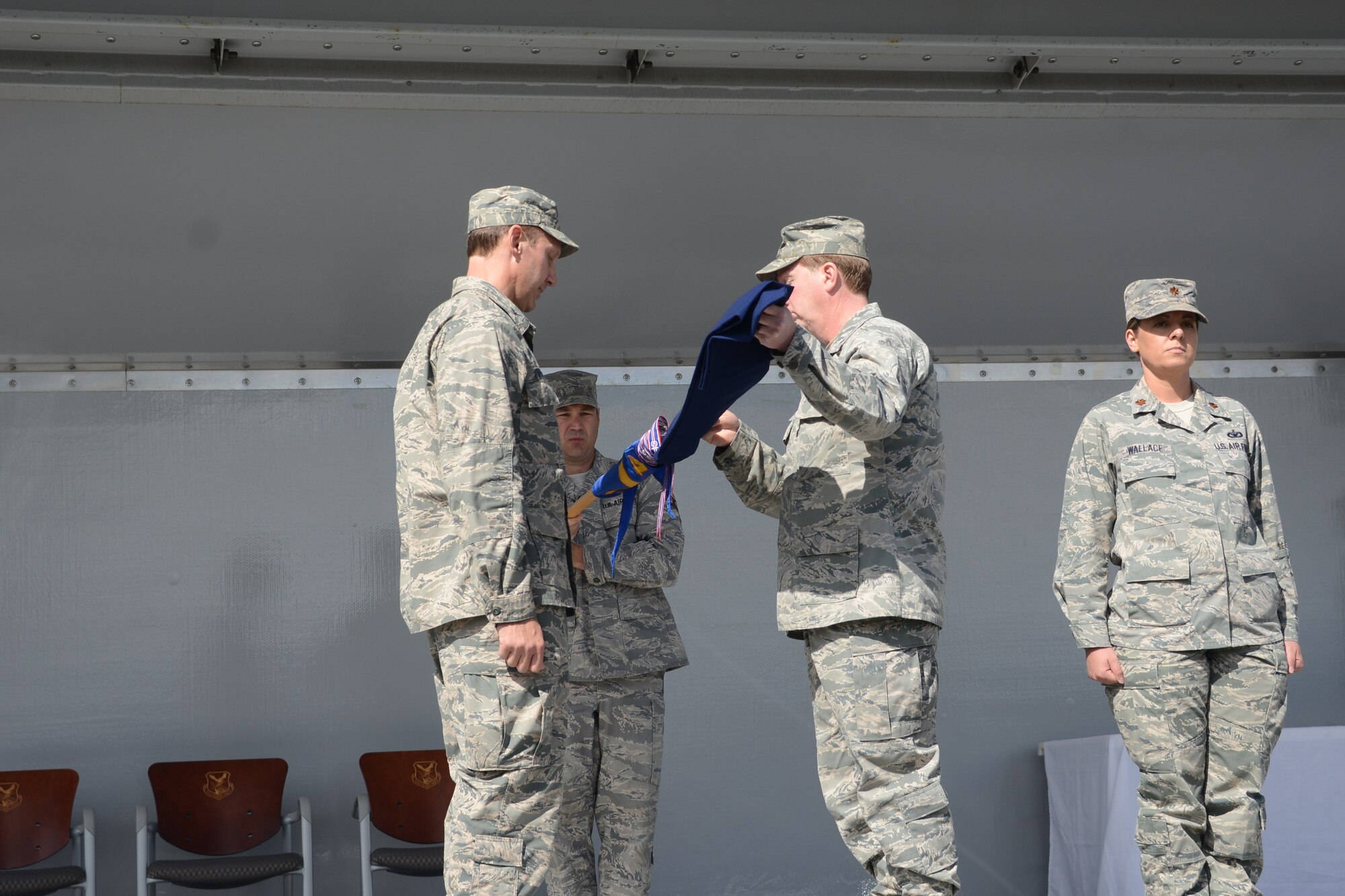 Lt. Col. Michael Forcht furled and capped the 477th Civil Engineer Squadron guidon, marking the end of more than 70 years of continued service for the squadron, during an inactivation ceremony on Joint Base Elmendorf-Richardson. (U.S. Air Force photo/Tech. Sgt. Dana Rosso)

