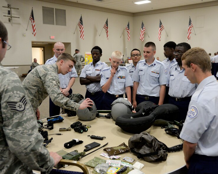 Airmen from the 2nd Operations Support Squadron aircrew flight equipment, describe various lifesaving equipment pilots use during JROTC Career Day on Barksdale Air Force Base, La., June 10. Barksdale units showcased their individual career fields to increase public awareness and understanding of mission and programs of the 2nd Bomb Wing. (U.S. Air Force photo/ Senior Airman Jannelle Dickey)