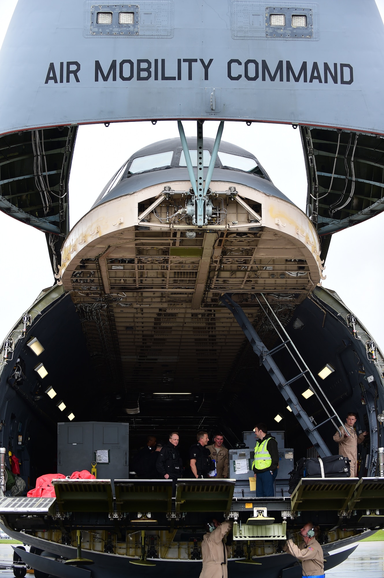 Members of the 420th Air Base Squadron, Ministry of Defence Police and 436th Air Wing, prepare the C-5 Super Galaxy for cargo unloading, June 2, 2015, at RAF Fairford, United Kingdom, in support of the U.S. European Command Exercises BALTOPS 15 and SABER STRIKE 15 from June 5-21, 2015. RAF Fairford is considered a ‘warm’ base and changed to ‘hot’ status, in support of the Air Force Global Strike Command’s involvement in the BALTOPS and Saber Strike 15 exercises. (U.S. Air Force photo by Tech. Sgt. Chrissy Best)