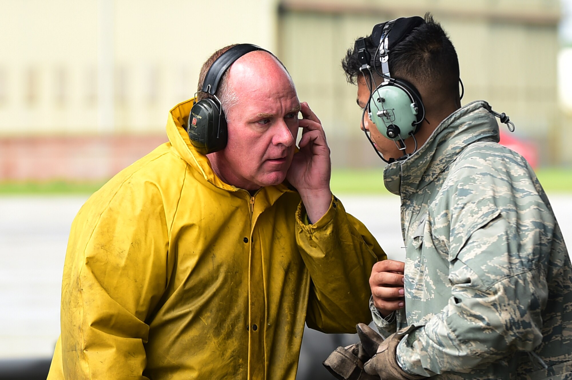 Gerald Leydon, 420th Air Base Squadron, fuel tech contractor, speaks with a C-5 crew chief from Dover Air Force Base Del., after landing on RAF Fairford, United Kingdom, June 2, 2015. The C-5 Super Galaxy landed on RAF Fairford in support of U.S. European Command Exercises BALTOPS 15 and SABER STRIKE 15 from June 5-21, 2015. (U.S. Air Force photo by Tech. Sgt. Chrissy Best)