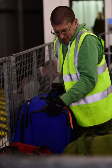 Steve Hibberd, 420th Air Base Squadron, heavy equipment operator stacks luggage that has been cleared by customs to be delivered to the dorms, for the recent deployers to RAF Fairford, United Kingdom, June 2, 2015. The deployers arrived to support the U.S. European Command Exercises BALTOPS 15 and SABER STRIKE 15 from June 5-21, 2015. (U.S. Air Force photo by Tech. Sgt. Chrissy Best))