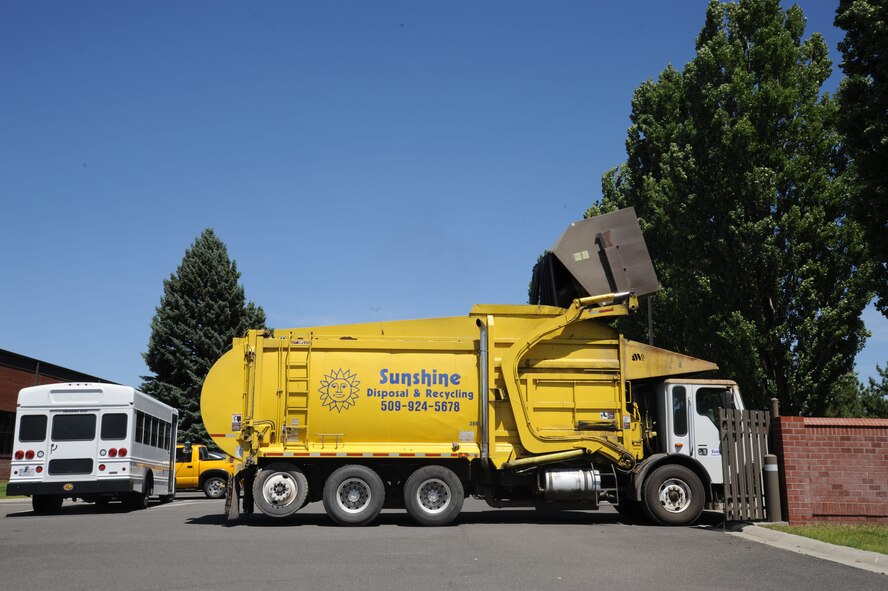 A Sunshine Recycling and Disposal truck, operated by a contracted driver, disposes of articles of refuse from one of Fairchild Air Force Base’s many on-base dumpsters at Fairchild Air Force Base, Wash., June 9, 2015. The trash is then taken to the Waste to Energy plant in Spokane, Wash. (U.S. Air Force photo/Senior Airman Sam Fogleman)