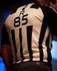 A jersey is worn by Ed Hochuli, NFL referee, on stage at Minot Air Force Base, N.D., June 5, 2015. The jersey, with the number 85, has been the same jersey Hochuli has worn over his entire career as an NFL referee. (U.S. Air Force photo/Airman 1st Class Sahara L. Fales) 
