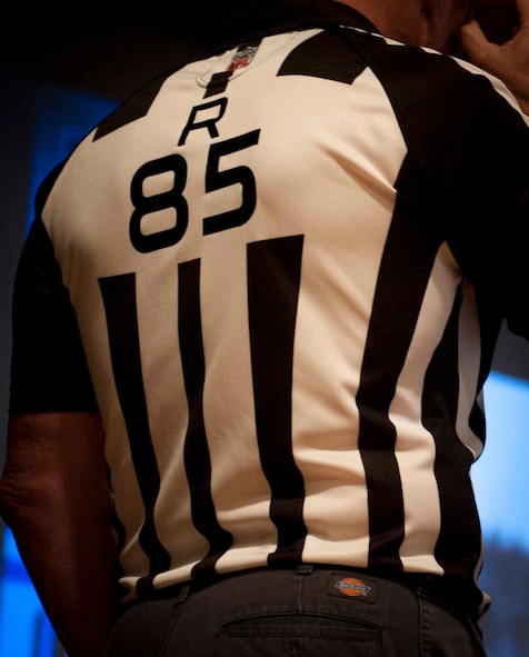 A jersey is worn by Ed Hochuli, NFL referee, on stage at Minot Air Force Base, N.D., June 5, 2015. The jersey, with the number 85, has been the same jersey Hochuli has worn over his entire career as an NFL referee. (U.S. Air Force photo/Airman 1st Class Sahara L. Fales) 
