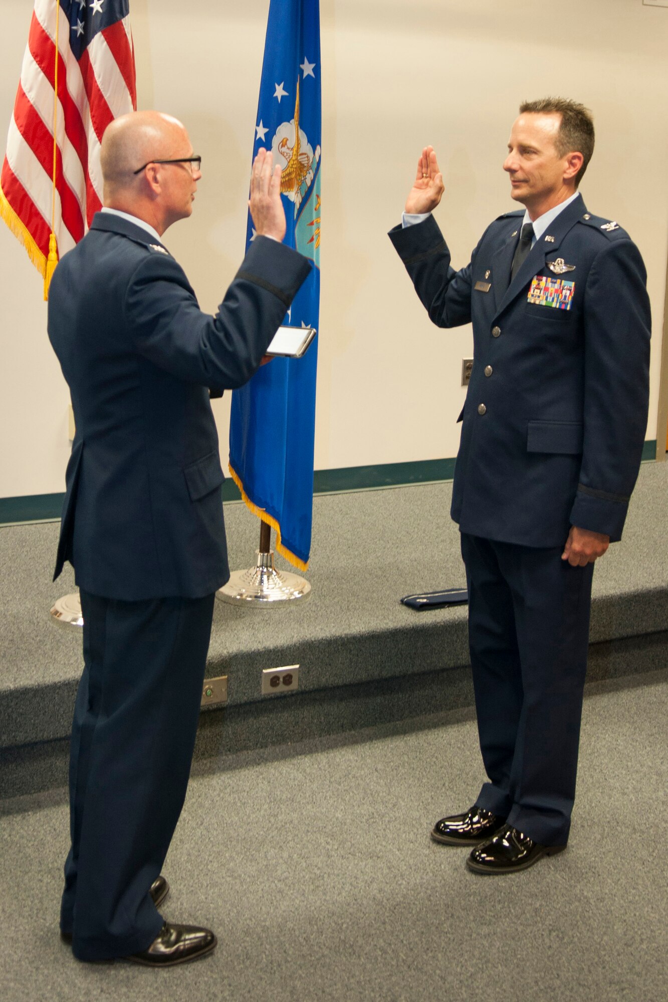 U.S. Air Force Col. Jon Ellis, Air Force Global Strike Command Mobilization Assistant to the Director of Operation, administers the oath of office to Col. Denis Heinz, 489th Bomb Group commander, during a ceremony that Heinz was promoted to the rank of Colonel on Barksdale Air Force Base, June 6, 2015. (U.S. Air Force photo by Master Sgt. Dachelle Melville/Released)
