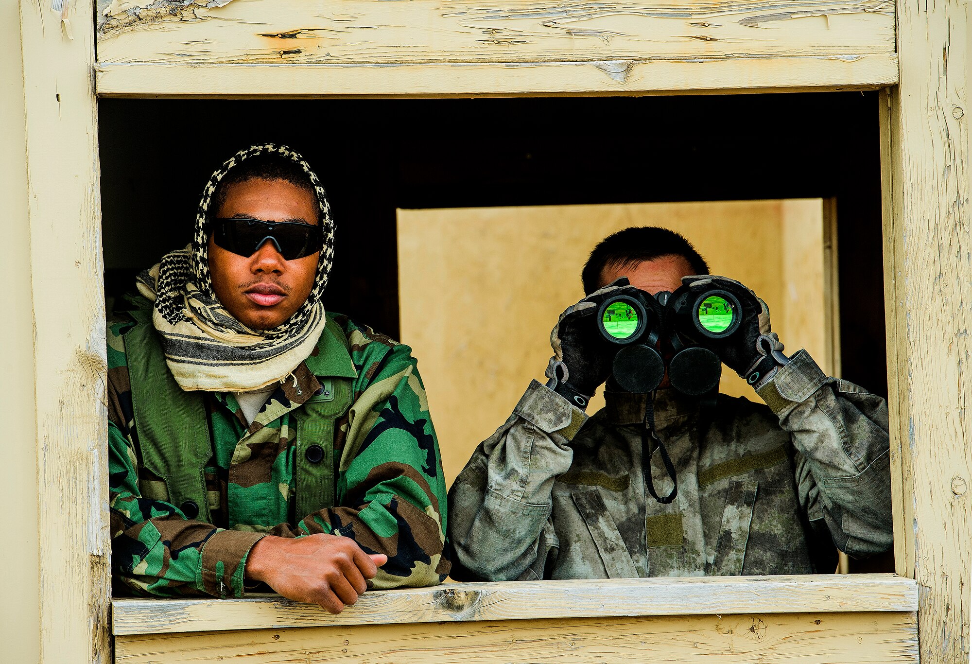 Senior Airman Brian Gill and Vidarion McDaniel, security forces airmen for the 570th Global Mobility Readiness Squadron from Travis Air Force Base, Calif., scan the area during an attack scenario on a missile convoy while working as opposing forces against the 91st Missile Wing, assigned to Minot Air Force Base, N.D., during Operation Road Warrior at Camp Guernsey, Wyo., May 18, 2015. 
Operation Road Warrior, the largest security forces exercise conducted each year, is an Air Force Global Strike Command exercise held annually at Camp Guernsey, Wyo., which evaluates tactics, techniques, and procedures used to secure nuclear–capable weapons and critical intercontinental ballistic missile (ICBM) components during convoy operations and provided direct feedback to the three participating ICBM wings; the 91st Missile Wing, assigned to Minot AFB, N.D., 90th Missile Wing assigned to F.E. Warren AFB, Wyo., and 341st Missile Wing assigned to Malmstrom AFB, Mont.. (U.S. Air Force photos by Tech. Sgt. Matthew Hannen)

