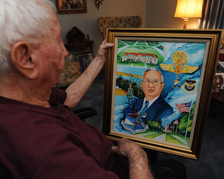 John Carpenter, World War II veteran, looks at his retirement portrait in Shreveport, La., June 3, 2015. Carpenter spent his post-military career working for the 8th Air Force Headquarters at Barksdale Air Force Base. (U.S. Air Force photo/ Senior Airman Jannelle Dickey)