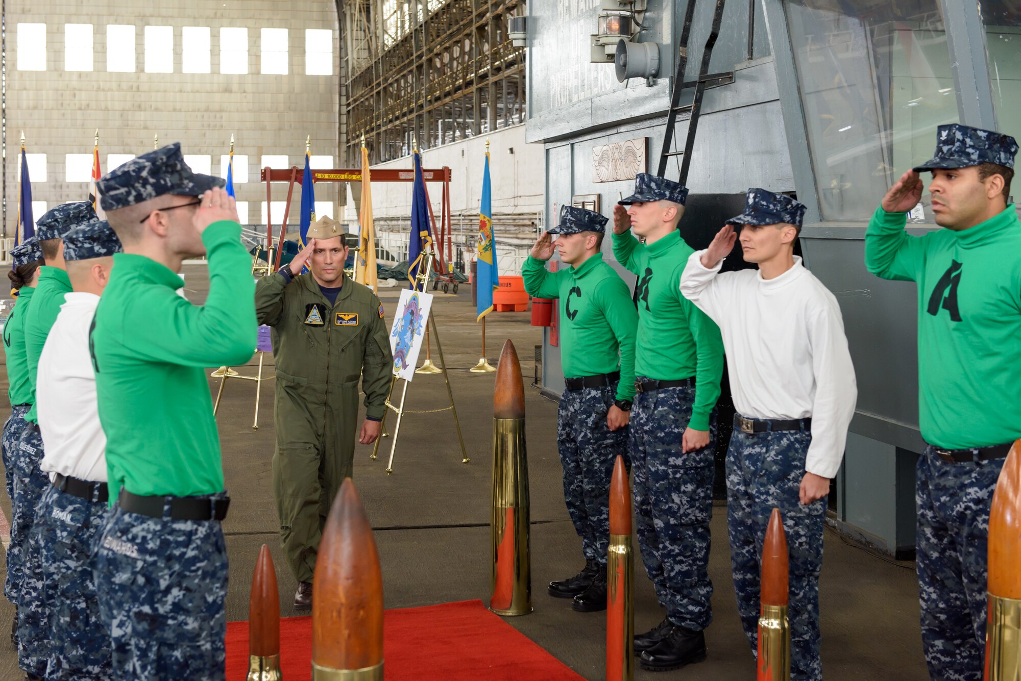 Navy Capt. Christopher Fletcher, Naval Support Activity Lakehurst commander and Joint Base McGuire-Dix-Lakehurst deputy commander, receives salutes from quarterdeck side boys aboard the flight deck in Hangar One, during the commemoration of the 73rd Anniversary of the Battle of Midway, June 6, 2015. (U.S. Air Force photo by Robert Williard/Released) 