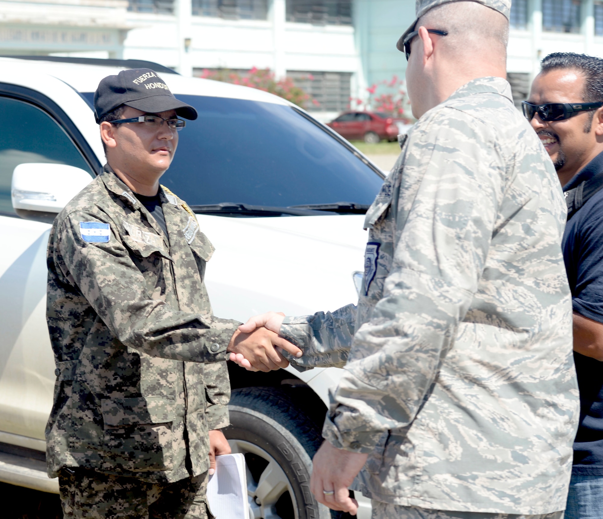 U.S. Air Force Col. James Sheedy, 474th Air Expeditionary Group and 612th Theater Operations Group commander, out of Davis-Monthan Air Force Base, Ariz., greets Honduran navy Lt. Mauricio Morazan, Puerto Castillo Navy Base operations chief, after landing at the base in Trujillo, Honduras, June 10, 2015. NEW HORIZONS Honduras 2015 personnel have been working closely with the Navy base to use their facility as a staging area for their equipment. “New Horizons is great for building partnership capacity. Special operations has a saying, “You only build support at the speed of trust,” and we can’t earn the trust of a whole other country without providing some help. Being able to support the local population with life sustaining and life enhancing opportunities it’s a great way to help build and build friendship,” said Sheedy.  Sheedy also visited exercise personnel at the Honduras Aguan well site, Gabriela Mistral primary school construction site, and saw the Dr. Salvador Paredos Hospital. Launched in the 1980’s, NEW HORIZONS is an annual joint humanitarian assistance exercise conducted by U.S. Southern Command with a partner nation in Central America, South America or the Caribbean. The exercise improves joint readiness training of U.S. and partner nation civil engineers, medical professionals and support personnel. (U.S. Air Force photo by Capt. David J. Murphy/Released)