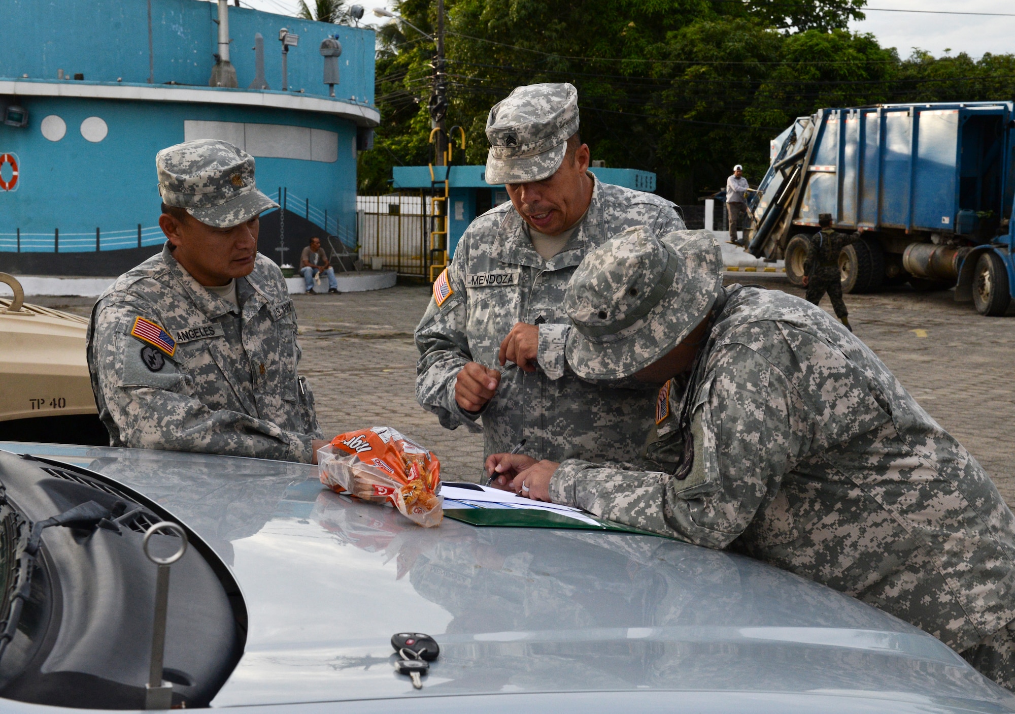 Sgt. Anthony Mendoza, a Joint Task Force – Bravo Joint Security Forces military police officer, reviews the outgoing convoy plan during the Corinto, Cortes medical readiness training exercise, June 4, 2015, at Puerto Cortes Naval Station, Honduras. The MEDRETE convoy consisted of more than 15 military vehicles, which were escorted to and from site by JSF personnel. (U.S. Air Force photo by Staff Sgt. Jessica Condit)