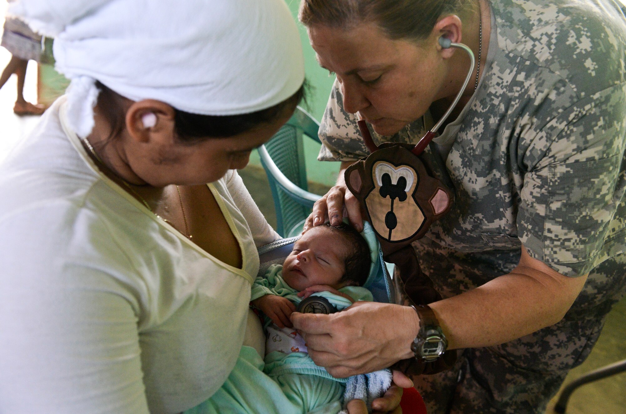 Lt. Col. Karen Rutherford, a Joint Task Force – Bravo Medical Element physician, performs a wellness check on a 13-day-old infant during a medical readiness training exercise June 2, 2015, at Corinto, Cortes, Honduras. The MEDRETE provided basic care and medication to more than 600 civilians of all ages. (U.S. Air Force photo by Staff Sgt. Jessica Condit)