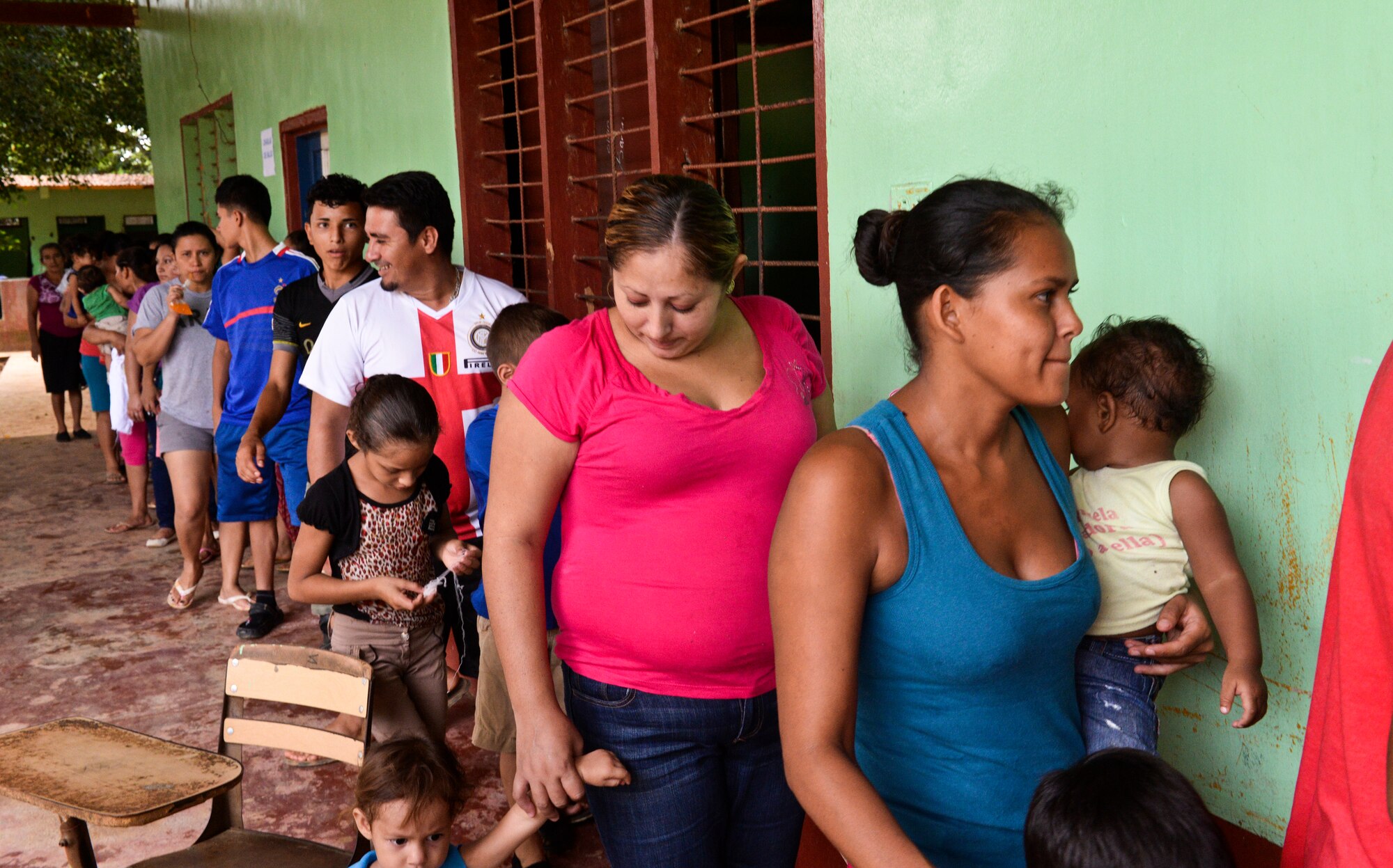 Families wait in line to participate in the health education class and receive medication during a medical readiness training exercise, June 2, 2015, at Corinto, Cortes, Honduras. Each family was provided the opportunity to learn proper procedures for treating illness and hygiene and was given any necessary medication. (U.S. Air Force photo by Staff Sgt. Jessica Condit)