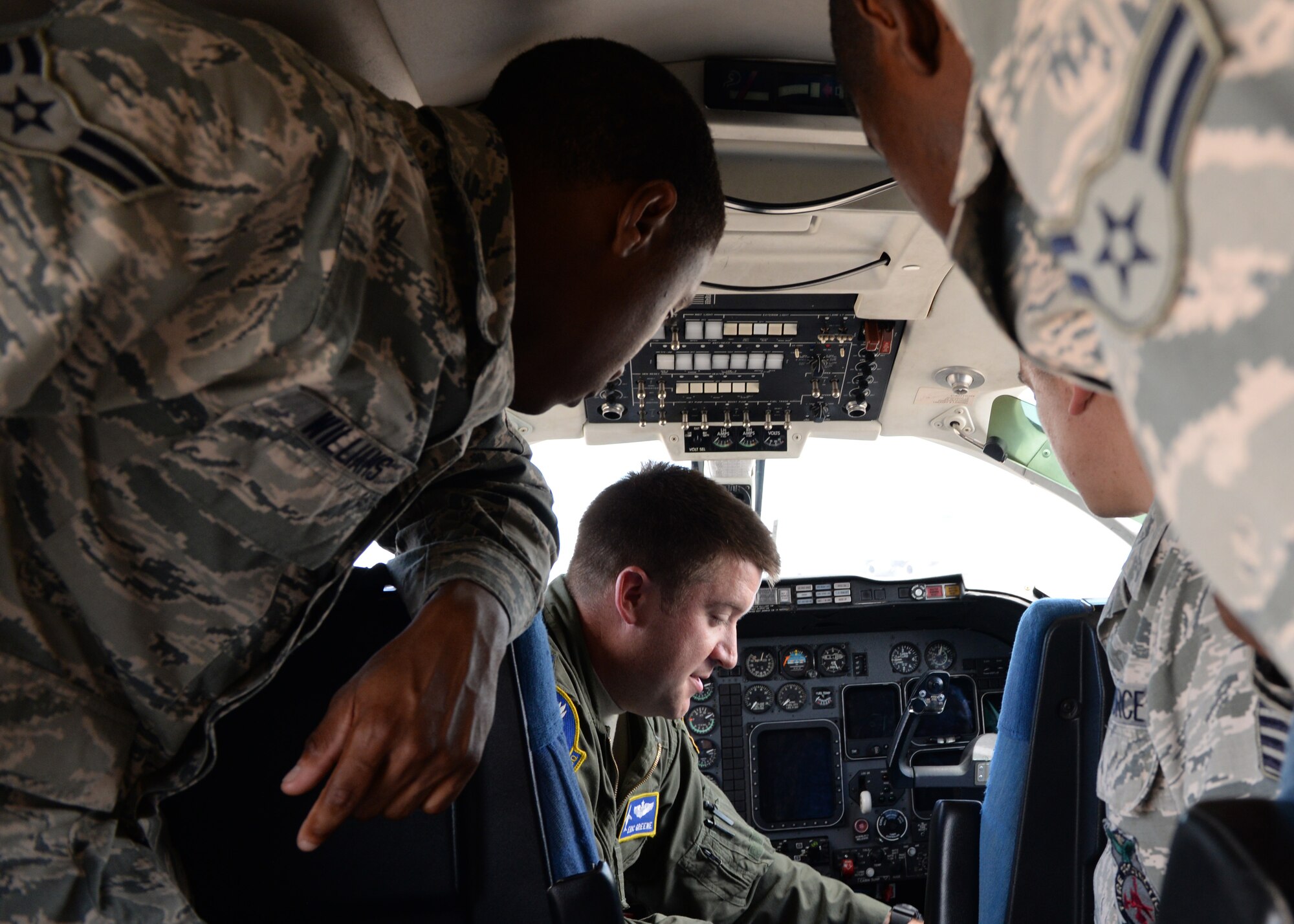 ALTUS AIR FORCE BASE, Okla. – U.S. Air Force Capt. Eric Green, 3rd Flying Training Squadron instructor pilot, Vance Air Force Base, shows firefighters from the 97th Civil Engineer Squadron how to extricate aircraft personnel from a T-1 Jayhawk and how to secure the aircraft during potential mishaps during egress training on the flight line, June 8, 2015. Typically the firefighters only train on the Altus AFB assigned aircraft, which are the U.S. Air Force KC-135 Stratotanker refueling aircraft and the U.S. Air Force C-17 Globemaster III cargo aircraft. However, they train on other aircraft whenever possible. (U.S. Air Force photo by Airman 1st Class Megan E. Acs/Released)