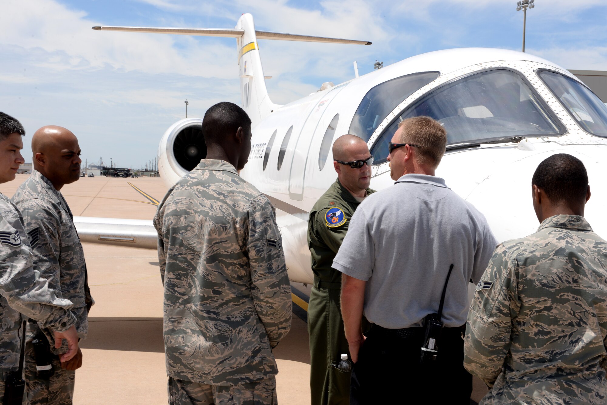 ALTUS AIR FORCE BASE, Okla. – U.S. Air Force Maj. Bill Lohan, 3rd Flying Training Squadron chief of training, Vance Air Force Base, familiarizes firefighters from the 97th Civil Engineer Squadron with the T-1 Jayhawk on the flight line for egress training, June 8, 2015. A few precautions firefighters take when egressing an aircraft are operating at safe distances when approaching the aircraft and knowing proper shut down procedures to isolate the power if the aircraft is involved in a fire. (U.S. Air Force photo by Airman 1st Class Megan E. Acs/Released)