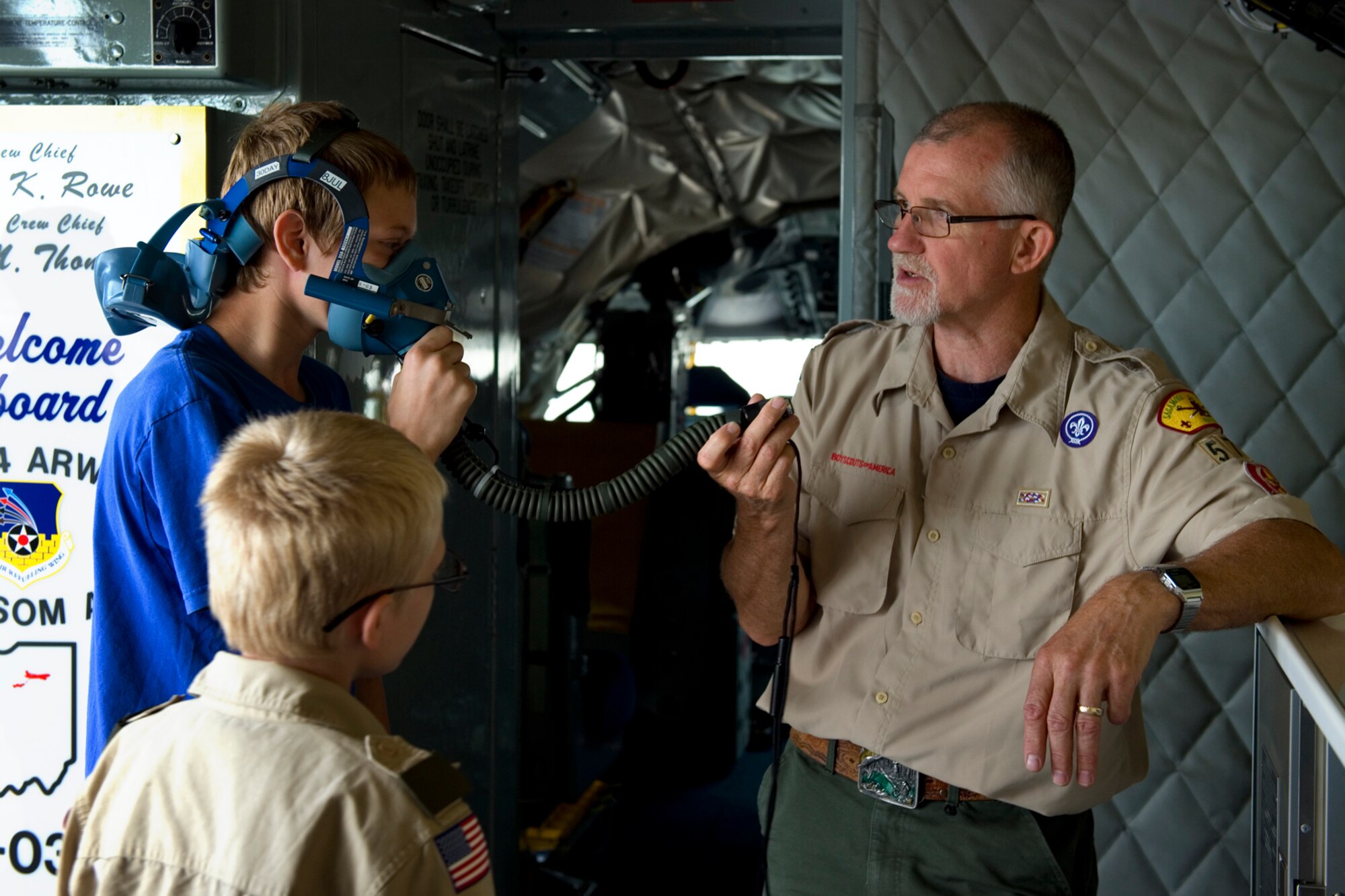 Retired Col. John Salmon, Boy Scout Troop 570 assistant scoutmaster from Kokomo, Ind., explains how an oxygen mask from a KC-135R Stratotanker works during a tour at Grissom Air Reserve Base, Ind., June 10, 2015. During the tour the group visited Grissom's propulsion shop in addition to a KC-135R static display.