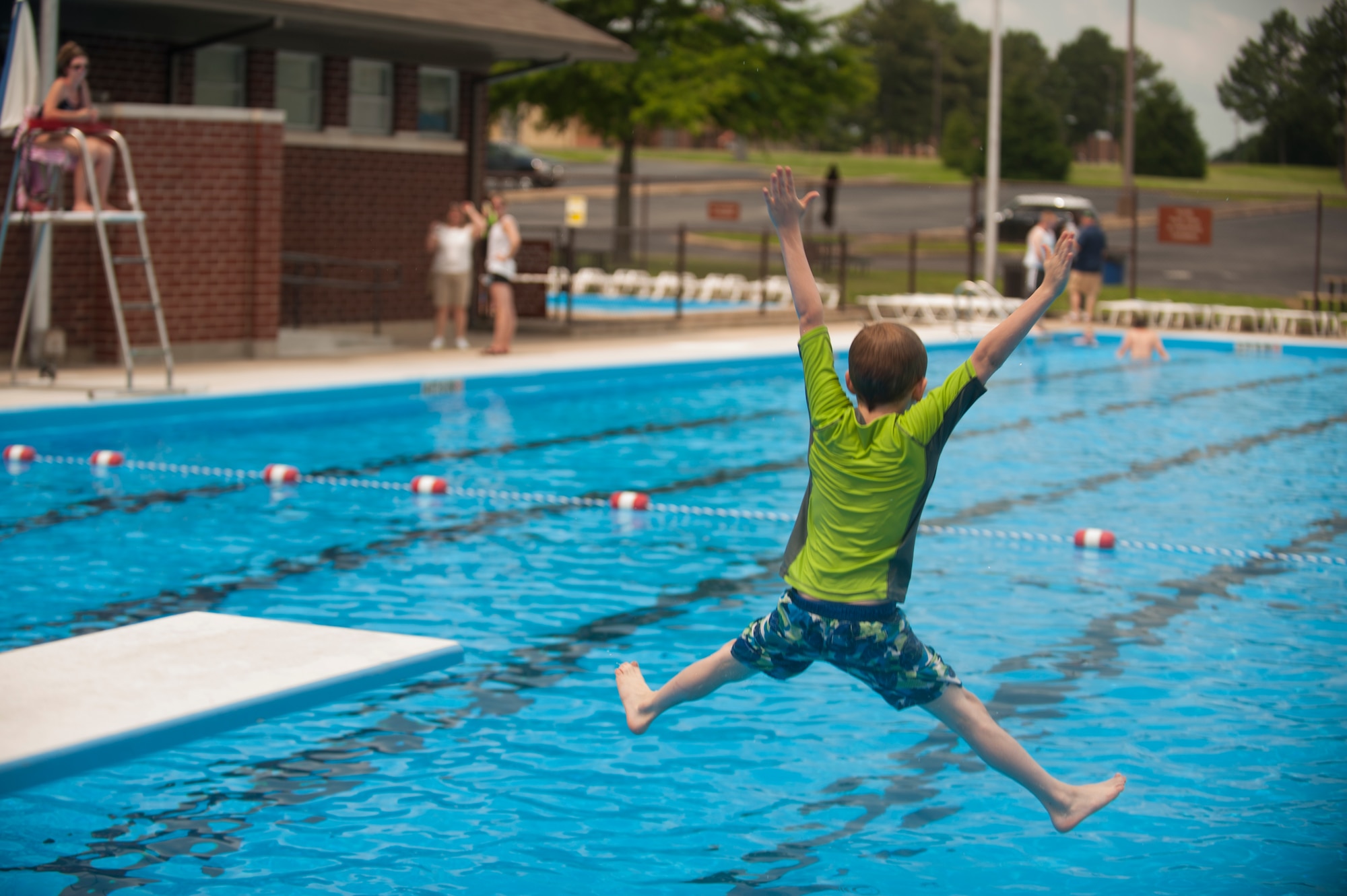 Coleman jumps into the base pool on opening day June 6, 2015, at Little Rock Air Force Base, Ark. Swimmers have the opportunity to take a jump from the diving board or enter the pool from the water slide. A day-pass costs $3, and season passes for single Airmen are $75 and for families are $125. (U.S. Air Force photo by Senior Airman Scott Poe)