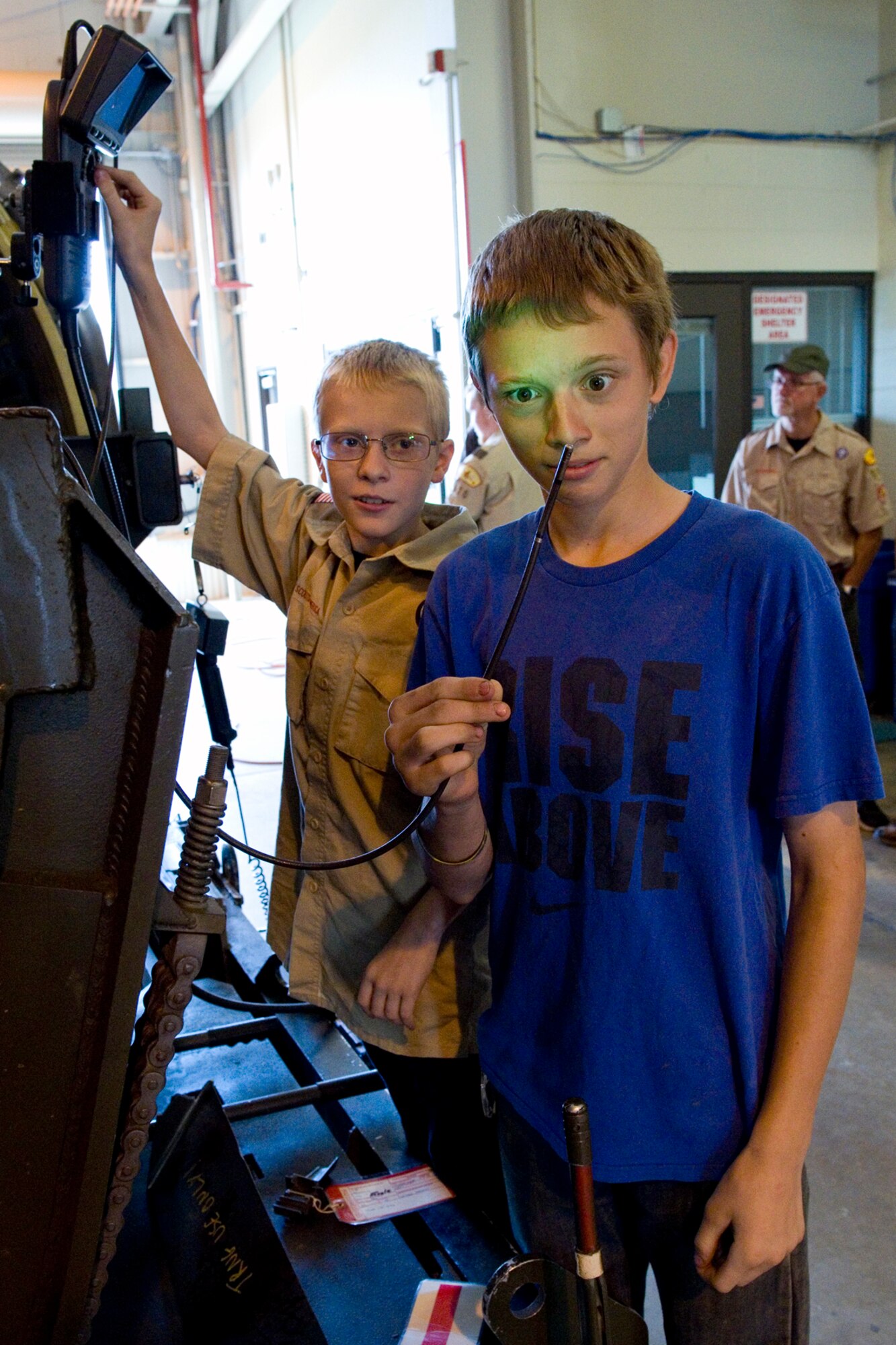 Cory Rowan, Troop 570 boy scout from Kokomo, Ind., looks at a camera on the end of a borescope inspection device as his brother Kyle Rowan uses a toggle switch to rotate the camera during a tour at Grissom Air Reserve Base, Ind., June 10, 2015. An engine borescope allows propulsion technicians to get a closer look at the internal workings of an aircraft engine without disassembling the engine. (U.S. Air Force photo/Tech. Sgt. Benjamin Mota)