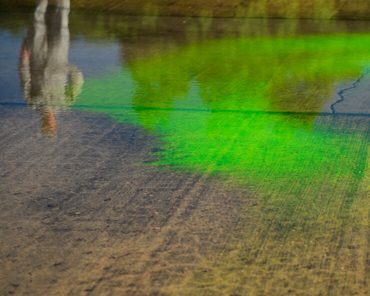 An Airmen surveys a simulated contaminate to determine its impact during an oil spill response exercise on Barksdale Air Force Base, La., June 10, 2015. As part of the exercise, various agencies train together to stop the spill at the source, barricade hazardous chemicals and remove contaminates from the soil and water. (U.S. Air Force photo/Airman 1st Class Mozer O. Da Cunha)
