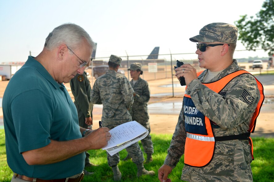 Tech. Sgt. Scott Strobel, 2nd Civil Engineer Squadron firefighter simulates the role of the incident commander during an oil spill response excercise on Barksdale Air Force Base, La., June 10, 2015. The incident commander is responsible for all incident activities, including the development of stategies and tactics and the ordering and release of resources needed for the operation. (U.S. Air Force photo/Airman 1st Class Mozer O. Da Cunha)