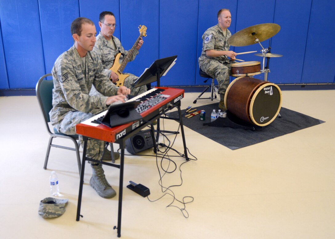 U.S. Air Force Staff Sgt. Michael Henrie, Heritage of America Blue Aces percussionist and technical sergeant select, plays the drums during promotion party at Langley Air Force Base, Va., June 9, 2015. The party congratulated 198 Langley technical sergeant selects. (U.S. Air Force photo by Airman 1st Class Devin S. Michaels/Released)