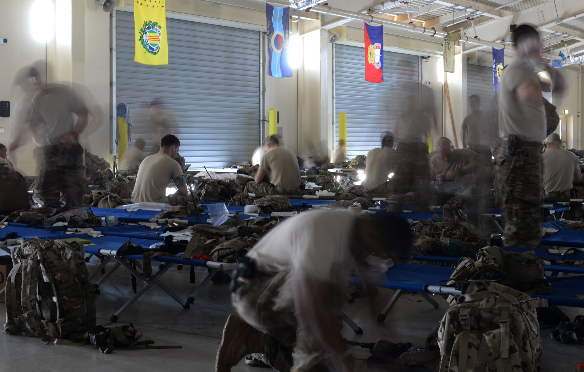 U.S. Army paratroopers from the 173rd Airborne Brigade, Vicenza, Italy pack up jump gear at the Personnel Alert Holding Area, June 9, 2015, at Aviano Air Base, Italy. The U.S. Army and German Armed Forces deployed to Lithuania for a five-month joint training exercise. (U.S. Air Force photo by Airman 1st Class Cary Smith/Released)