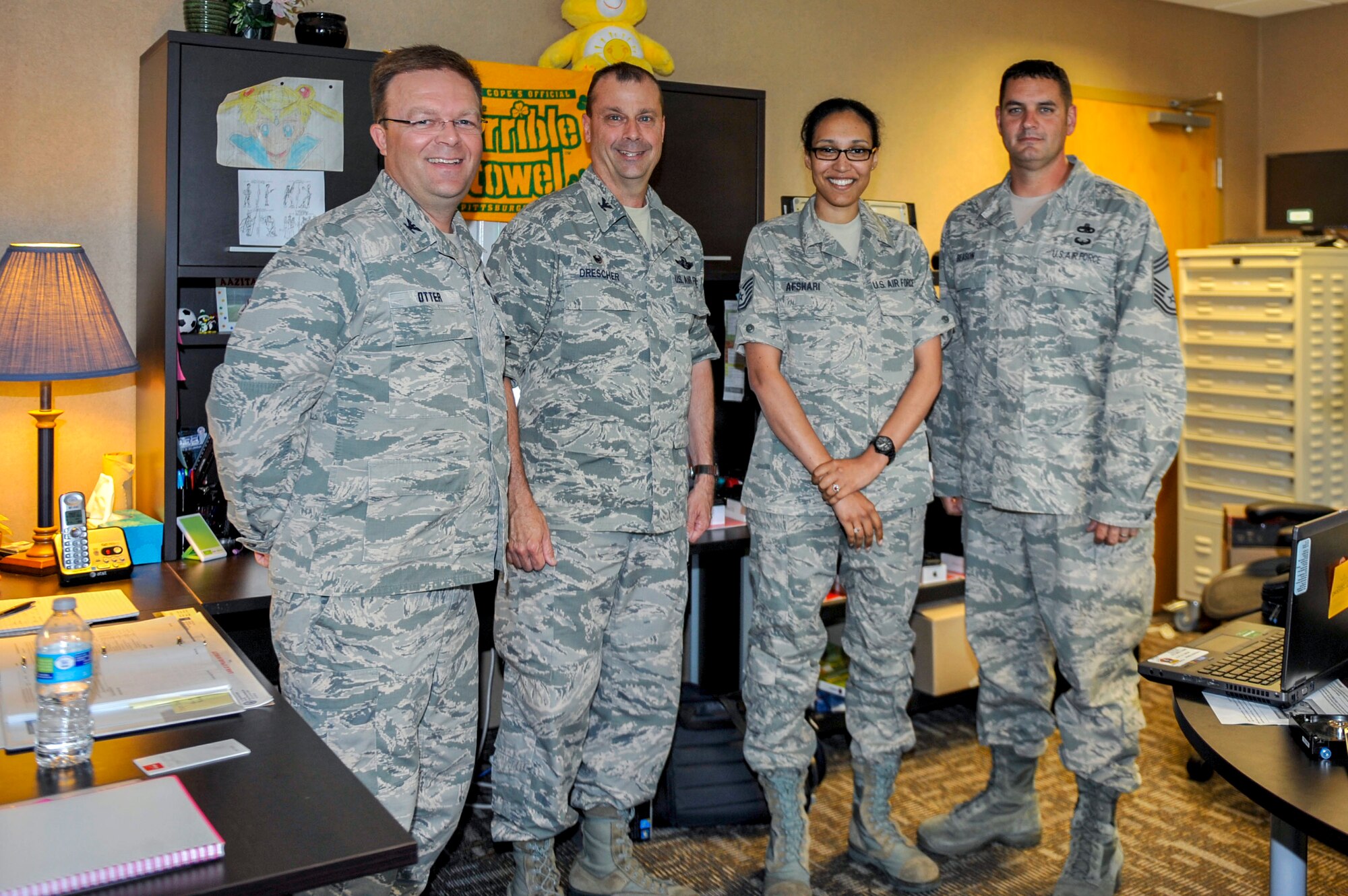 Col. Bill Otter, 19th Airlift Wing vice commander, along with other Team Little Rock leadership congratulate Tech. Sgt. Aazita Afshari, a 913th Airlift Group non-commissioned officer in charge of records management, for her selection as Combat Airlifter of the Week June 8, 2015, at Little Rock Air Force Base, Ark.  Afshari simultaneously managed two additional full time vacant air force specialty code positions. (U.S. Air Force photo by Senior Airman Stephanie Serrano)