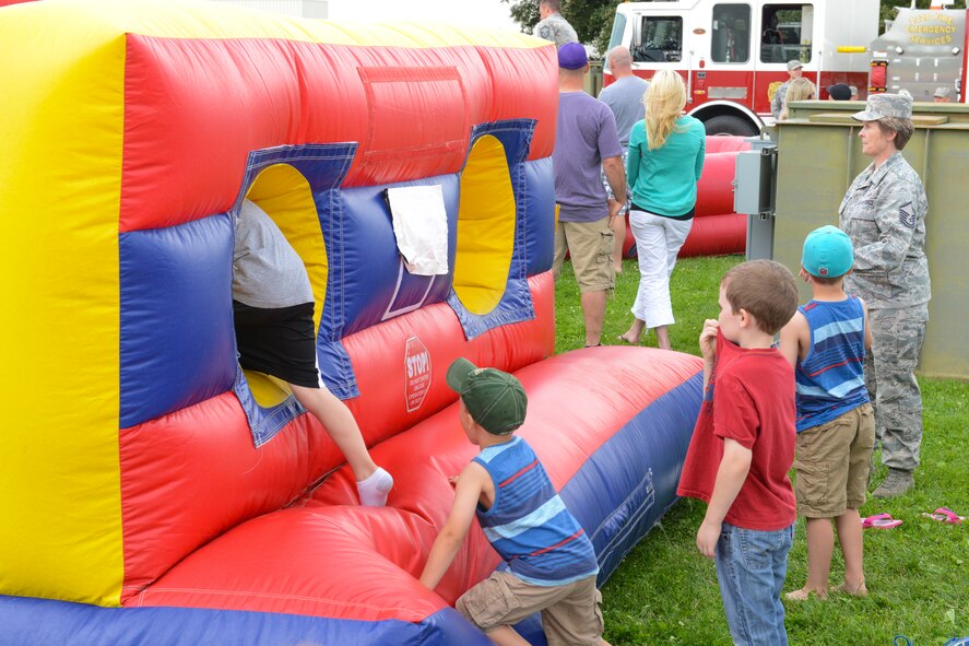 Members of the 132d Wing (132WG), Des Moines, Iowa and their families participate in the 2015 Annual Family Day held at the 132WG on Saturday, June 6, 2015. Children play on the inflatables during the 2015 Wing Family Day at the 132d.  (U.S. Air National Guard photo by Senior Airman Michael J. Kelly/Released)