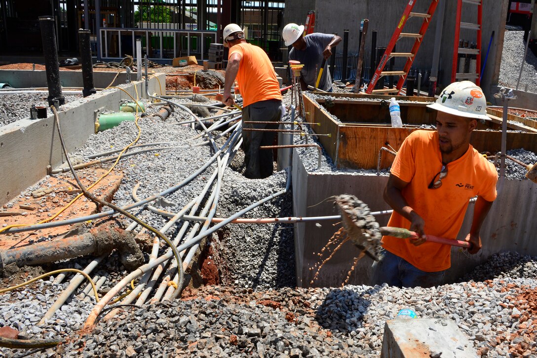 McGHEE TYSON AIR NATIONAL GUARD BASE, Tenn. -  Construction crew members dig out gravel around the elevator shaft pit on the grounds of the new dormitory facility under construction here. The gravel must be cleared to allow for the installation of support pylons for the elevator shaft.  (U.S. Air National Guard photo by Master Sgt. Jerry D. Harlan/Released)
